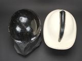 pair of black and white hats and a white hat on a black surface