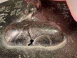 a hand that is holding a metal object with writing on it