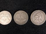 three different types of coins on a black surface