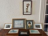 a table with pictures and pictures on it in front of a window