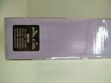 purple cloth with a black label on it sitting on a white surface