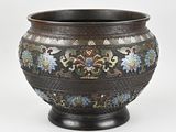 a black vase with a floral design on it