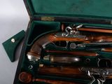 a case with a bunch of old guns inside of it