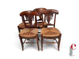 four wooden chairs with wicker seats on a white background