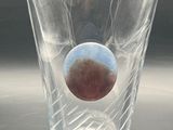a shot glass with a blue and red ball inside of it