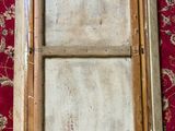 a close up of a wooden window on a red carpet