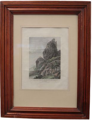 a framed picture of a mountain scene with rocks in the foreground