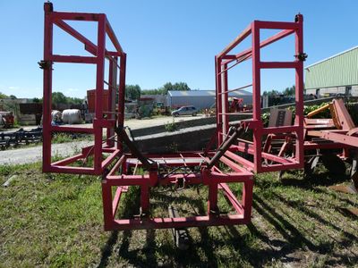 a red trailer that has a large piece of equipment on it