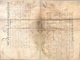 an old document with writing on it sitting on top of a table