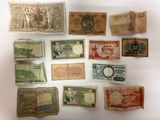 plusieurs types différents de billets de banque disposés sur une surface blanche