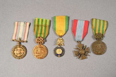 several medals are displayed on a table with a gray background