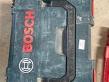 two tools are sitting on the floor next to a tool box