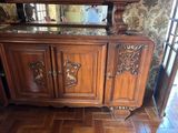 a wooden cabinet with a mirror on top of it