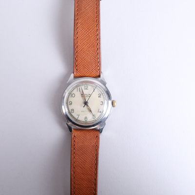 an image of a close up of a wrist watch on a white surface