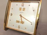 a gold clock that is sitting on a table