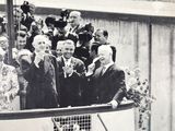 a black and white photo of a group of people on a boat