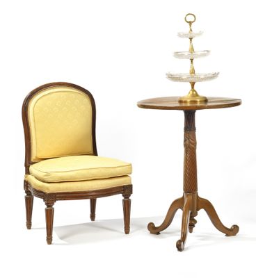 two chairs and a table with a glass bowl on top of it