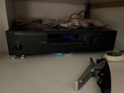 a picture of a remote control and a stereo system on a table