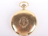 an antique gold pocket watch with a lion emblem on the front