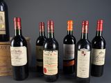 several bottles of wine are lined up in a row on a table