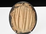 a black and gold plate sitting on a white table