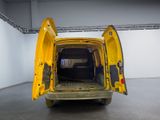 a yellow van with its door open in a white room