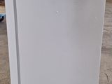 a white refrigerator that is sitting in a warehouse