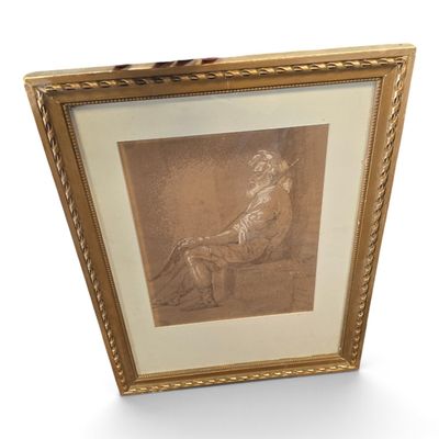 une vieille photo représentant une femme assise sur une chaise, dans un cadre doré