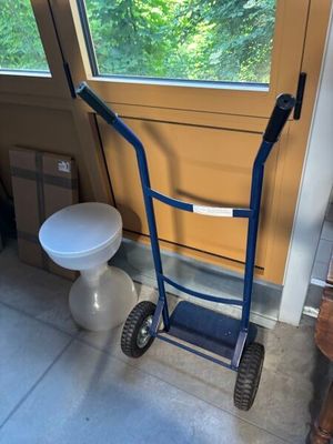 un diable bleu avec des toilettes en arrière-plan