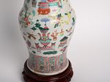 a vase that has been decorated with asian designs on it