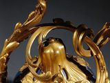 a blue vase with a gold decoration on it
