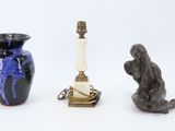 three vases and a lamp on a white surface