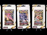 four packs of pokemon trading cards are lined up on a black background
