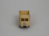 a yellow toy truck that is sitting on a white surface