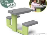 a small child ' s table with two benches on it