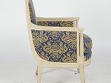 an upholstered chair with a blue and gold upholstered seat