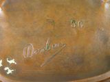 a close up of a bronze plate with writing on it