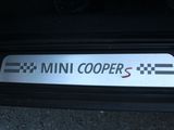a mini cooper sticker on the bumper of a car