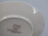 a close up of a white plate with a black writing on it