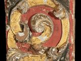 a picture of a decorative piece of wood with gold and red paint