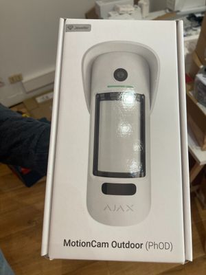 someone is holding a box with a remote control inside of it