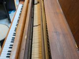 a piano that is sitting in a room next to a drum
