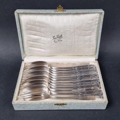 a set of six silverplated serving spoons in a case