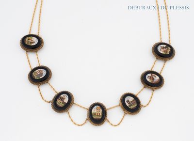 a close up of a necklace on a white surface