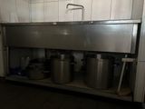 pots and pans are sitting on a shelf in a kitchen