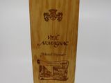 a wooden box with a bottle of wine in it