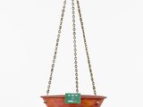 a brass hanging planter with a green tag on it