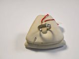 a ring that is sitting on top of a white bag