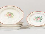 three plates with flowers on them sitting on a table