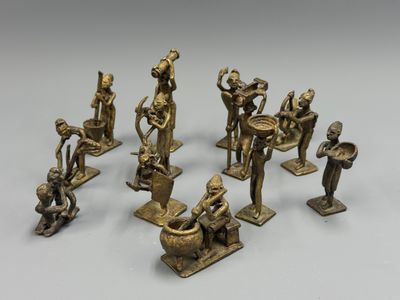 a group of bronze figurines of various sizes and shapes